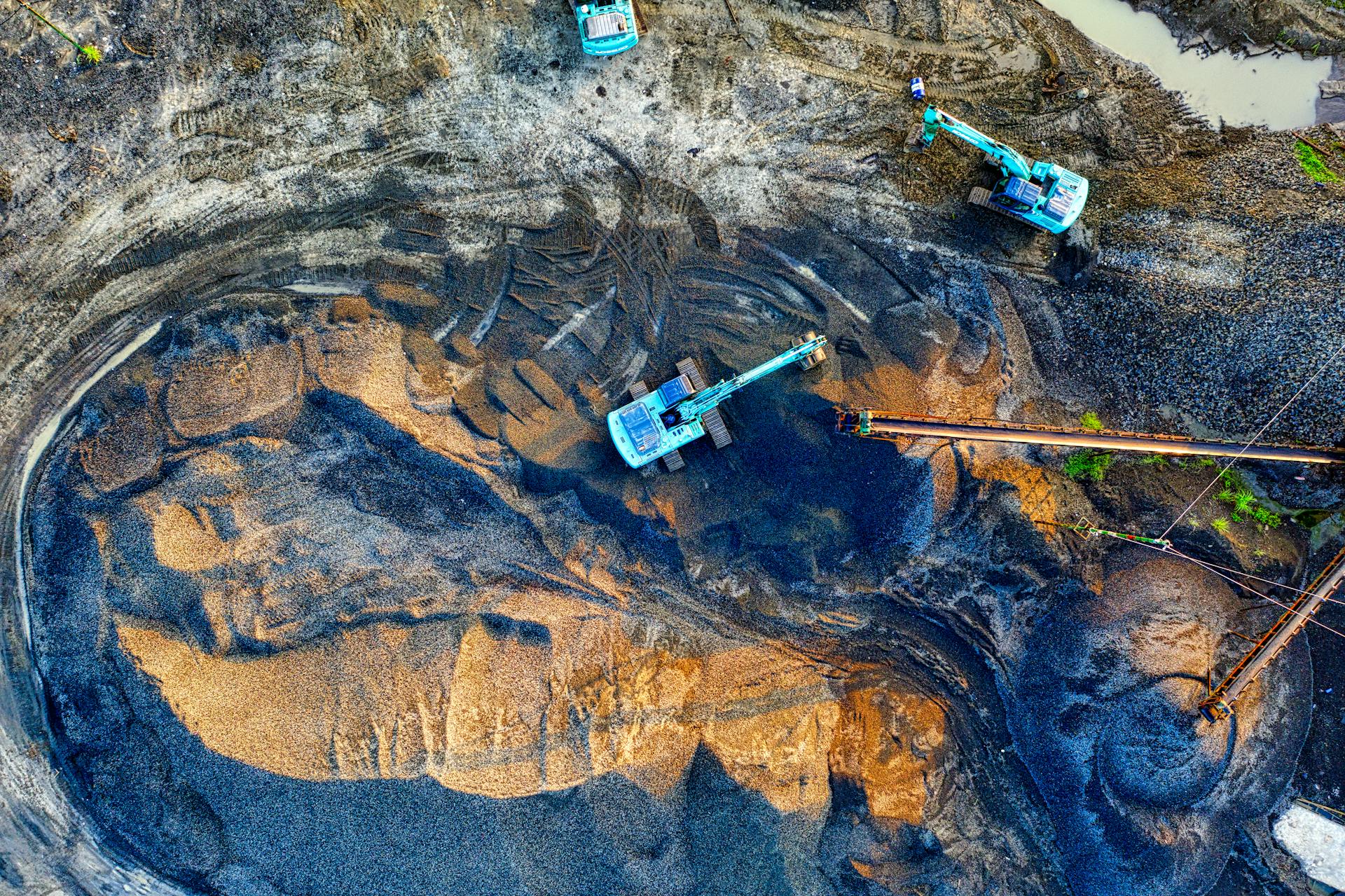 Aerial shot of an active mining site with machinery in Banten, Indonesia.