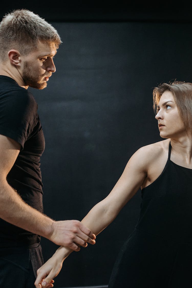 Man Holding Woman In Black Tank Top