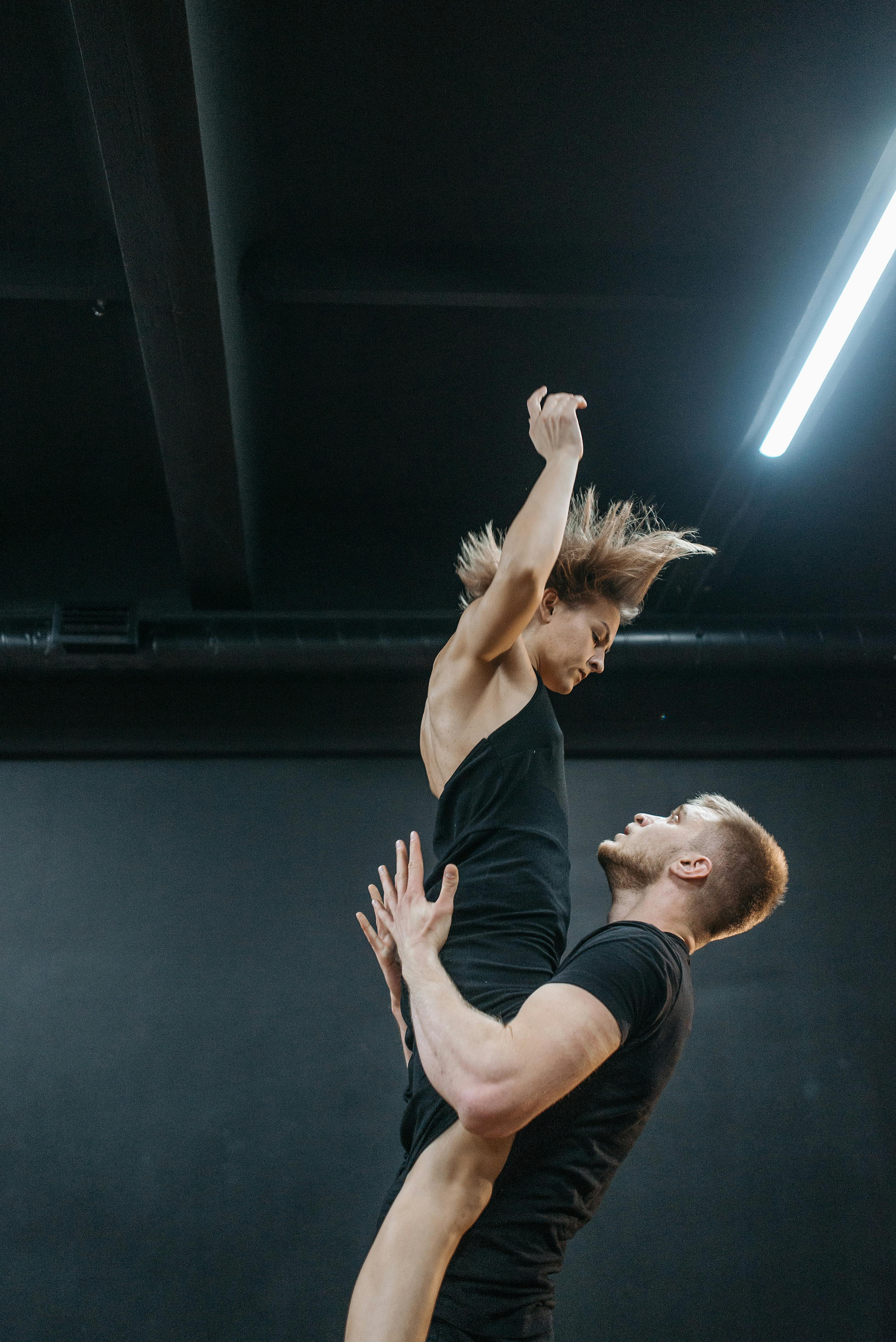 Premium Photo | Balance of male and female energies a female and male  contemporary dancer performing a dramatic pose in front of a dark background