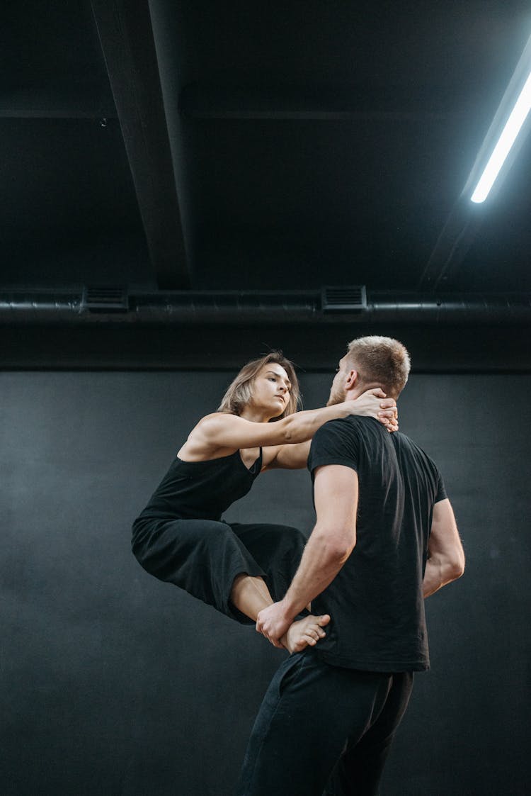 A Man Lifting His Partner While Holding His Neck