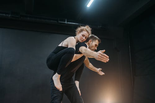 A Low Angle Shot of a Man Carrying a Woman on His Back