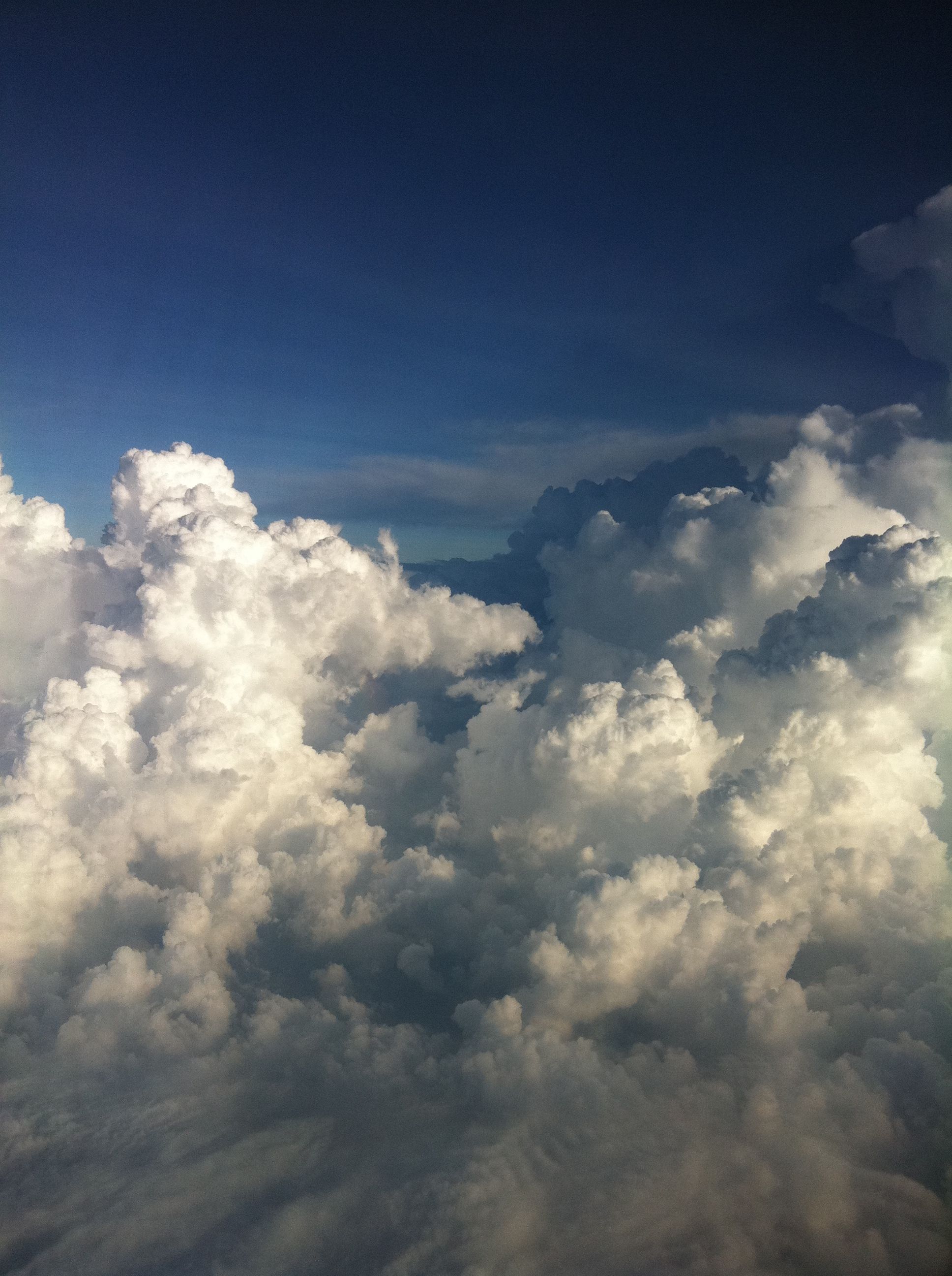 A vibrant cloudscape featuring cumulus clouds against a bright blue sky, evoking a sense of wonder and serenity.