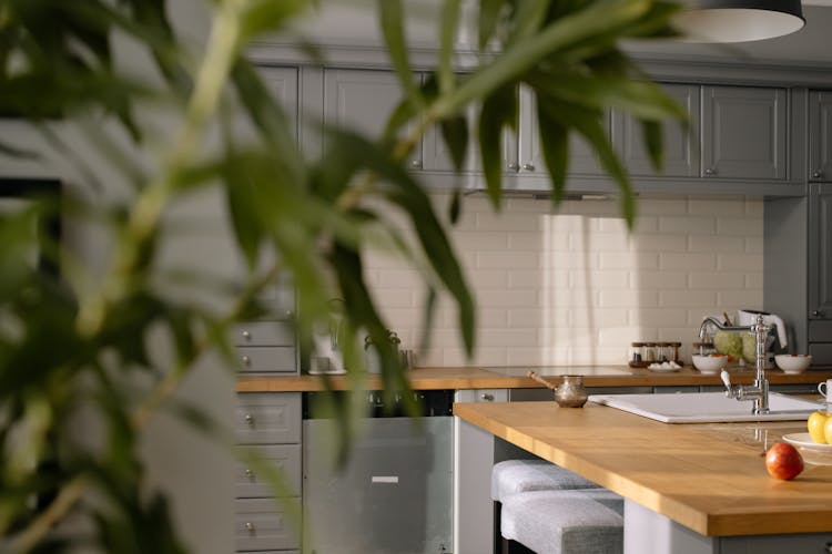 Kitchen Interior With Gray Cabinets And Wooden Counter Top