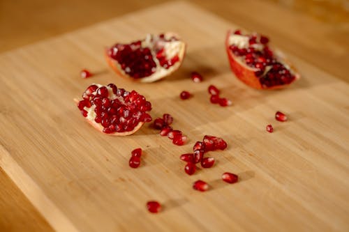 Free Close-Up Shot of Peeled Pomegranate on a Wooden Surface Stock Photo
