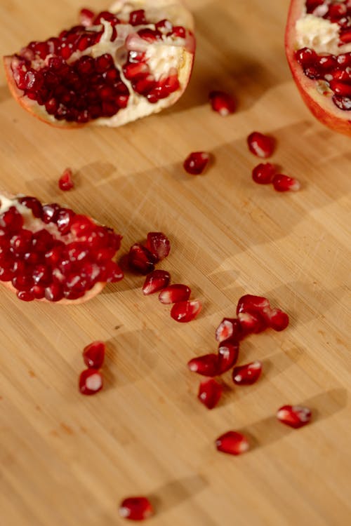 Sliced Pomegranate on Wooden Surface 