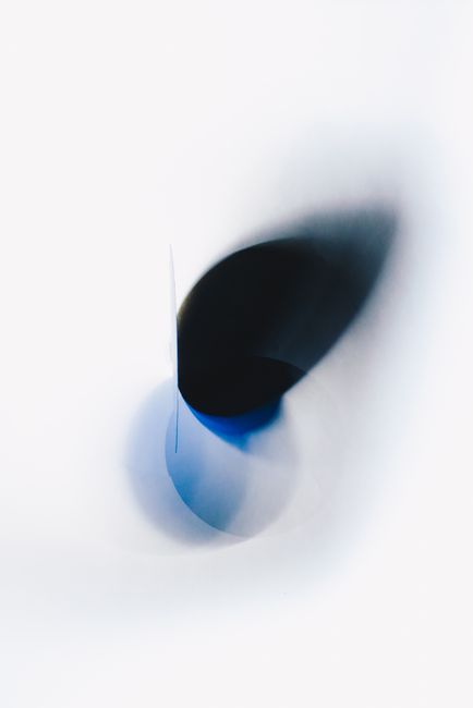 Ethereal abstract art with blue and black shapes on a white background.
