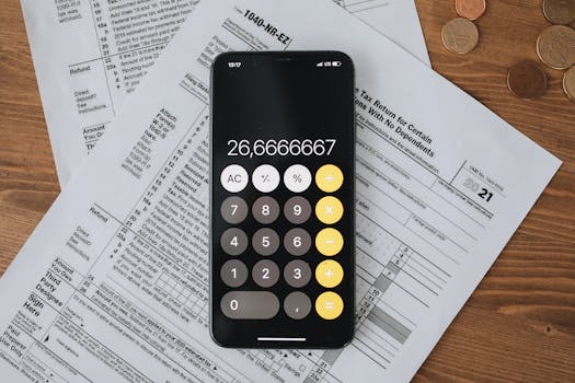 Mobile calculator app on tax documents, highlighting financial calculations and tax preparation.