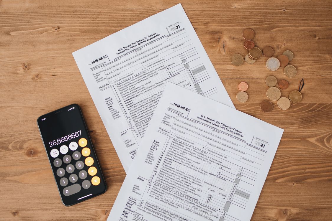 Tax papers with coins representing personal finance planning