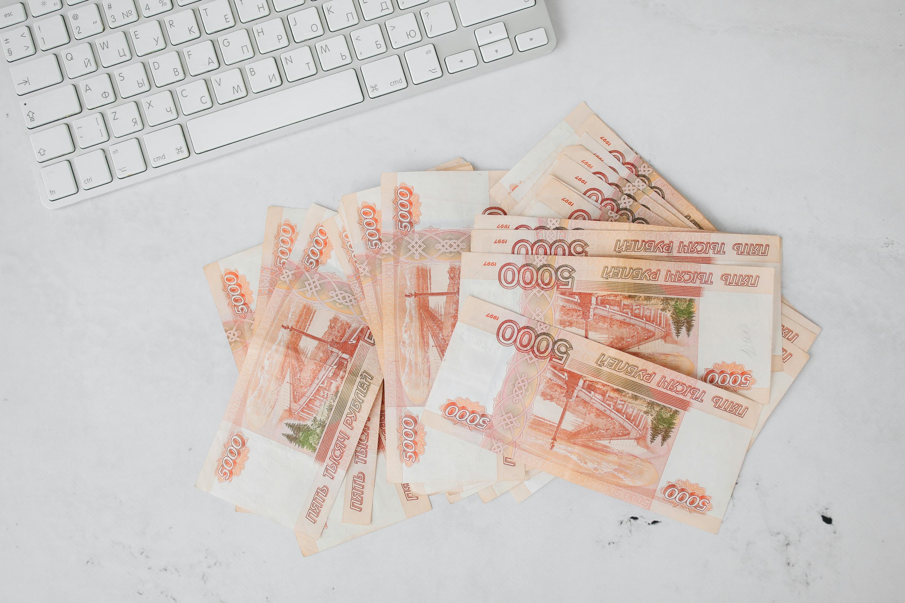 a computer keyboard and cash on a flat surface