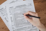 A Person Writing on White Paper