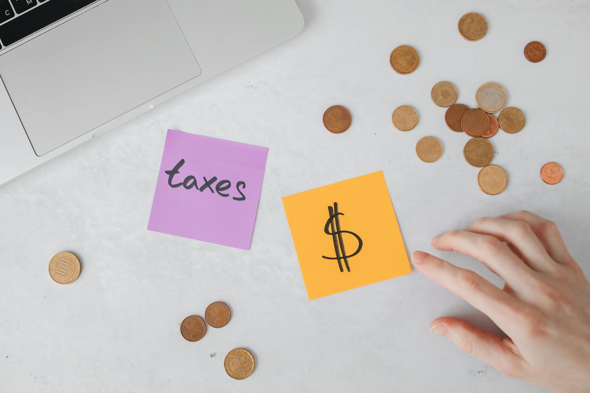 A Sticky Notes and Coins on the Table