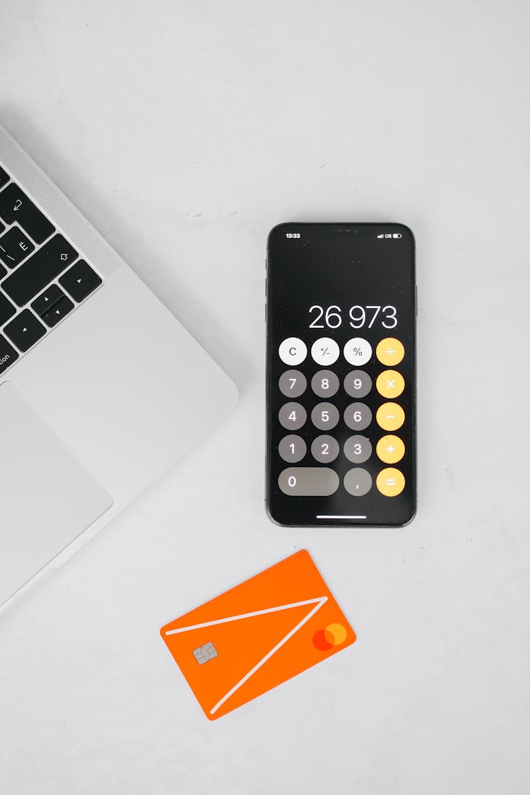 A Mobile Phone With Calculator On A White Surface