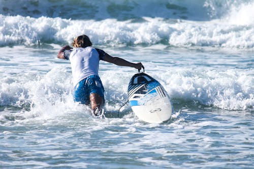 A Person Surfing on the Beach