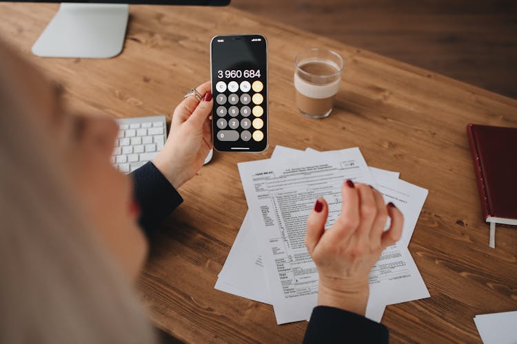 Person Holding Using A Calculator