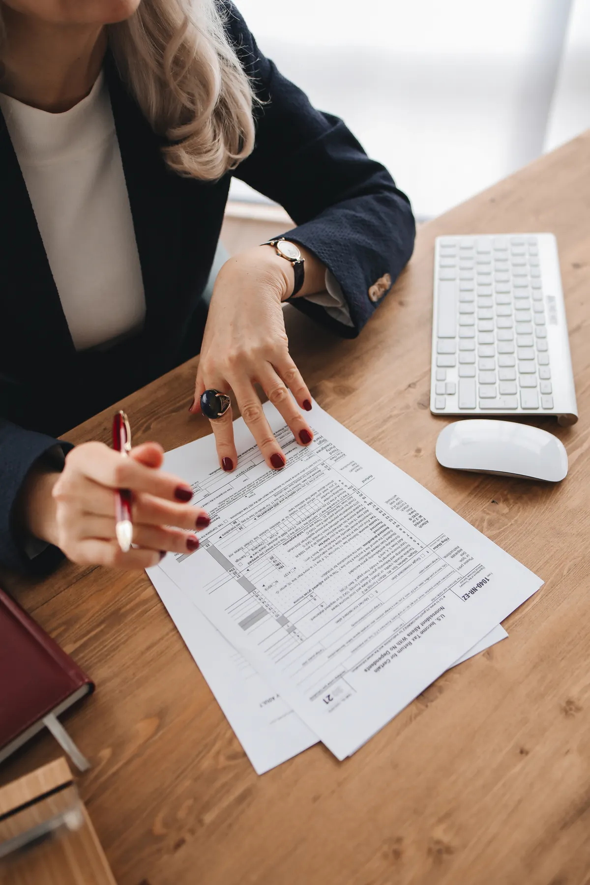 A tax preparer reviewing documents at their desk