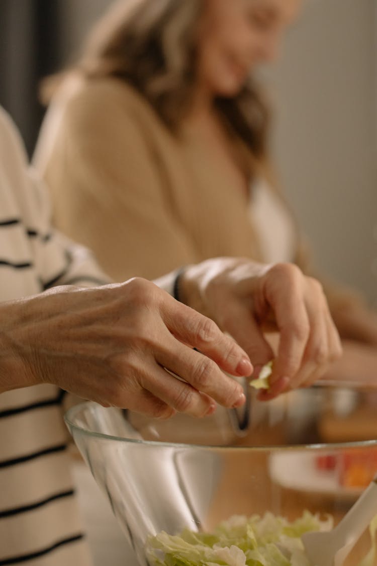 Hands Of A Woman Shredding Green Leaf