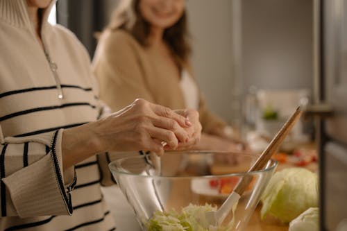Free A Person Preparing a Food on a Clear Glass Bowl Stock Photo