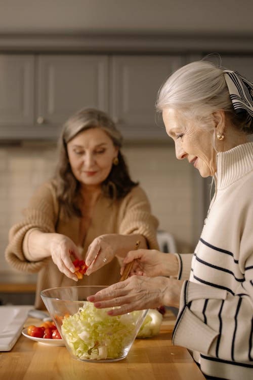 A Side View of an Elderly Woman in Turtle Neck Sweater Preparing a Food