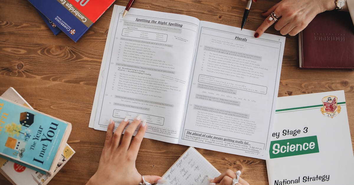 Overhead view of students studying with open books and taking notes, highlighting education and learning.