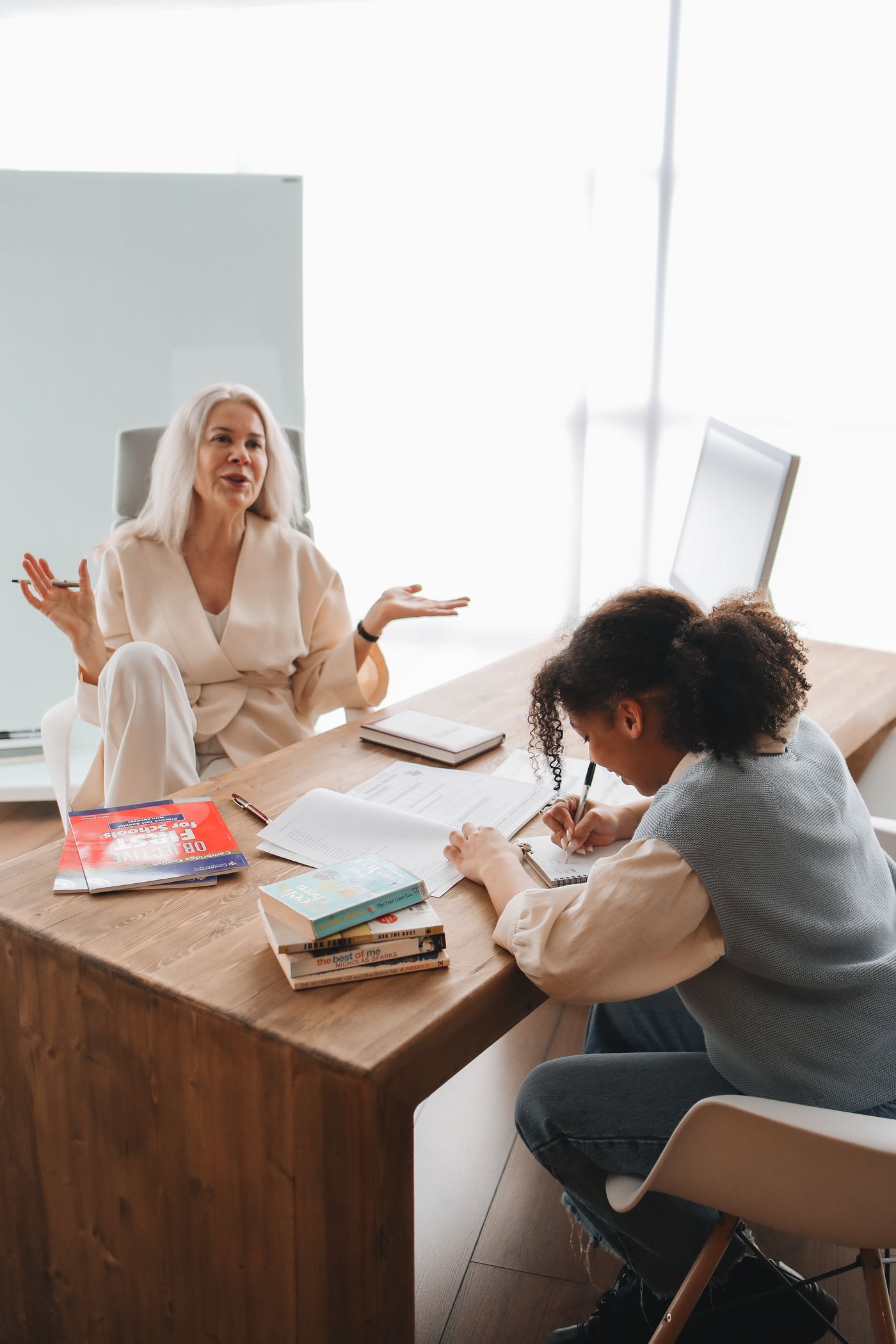 Tutor supporting a teenage learner during a focused study session