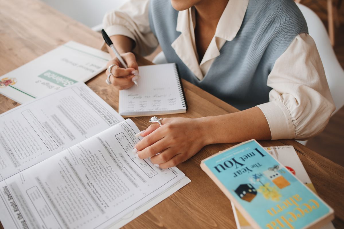 Student preparing handwritten notes for examination improvement