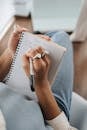 Student Writing Notes on Her Notebook