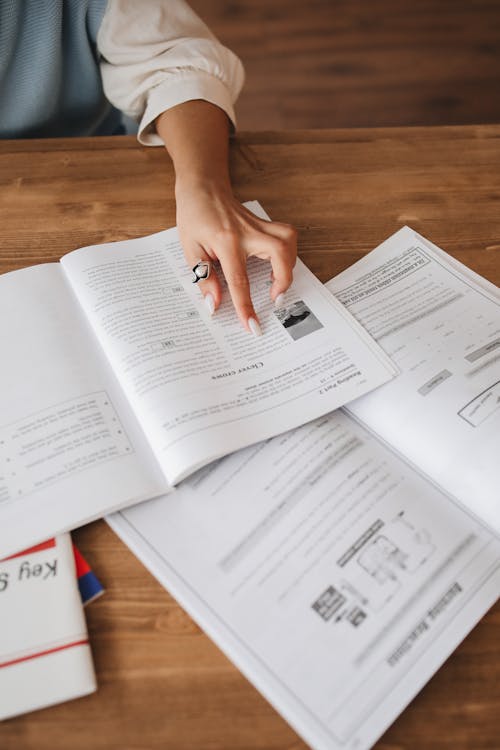 Free Person's Hand on a Book Stock Photo