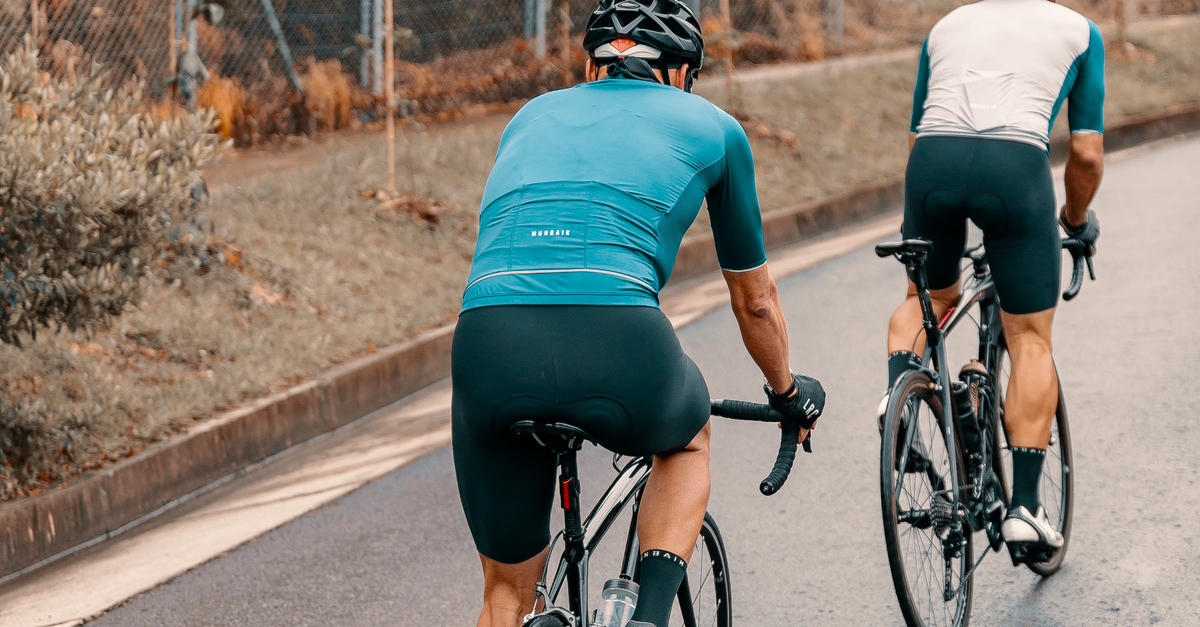 Two Men Riding on Bicycles on an Asphalt Road · Free Stock Photo