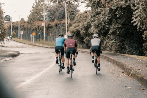 Three Men Riding Bikes