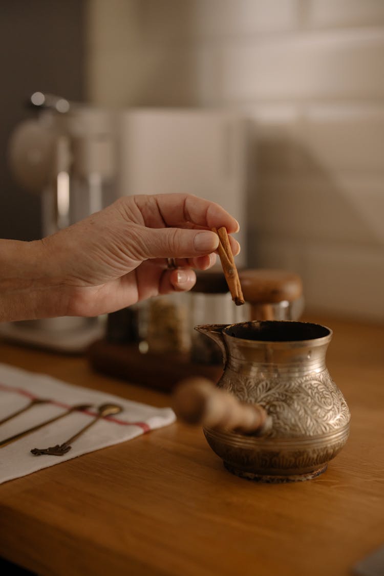 A Person Holding Cinnamon Sticks