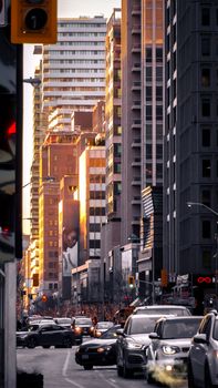 Bustling city street with high-rise buildings and traffic in a downtown district.