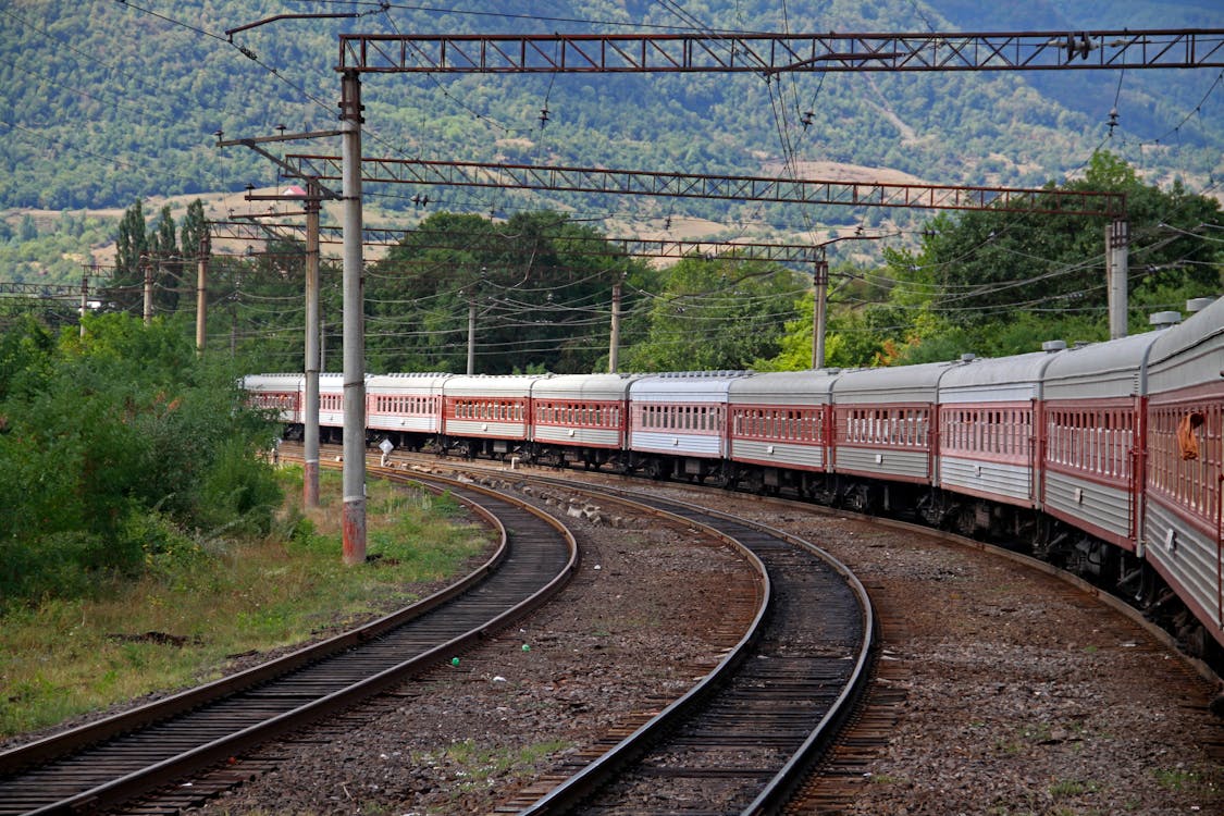 Red and Gray Train on Rail Tracks