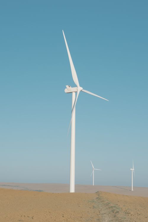 Free Wind turbines stand tall under a clear blue sky in South Africa, harnessing green energy. Stock Photo