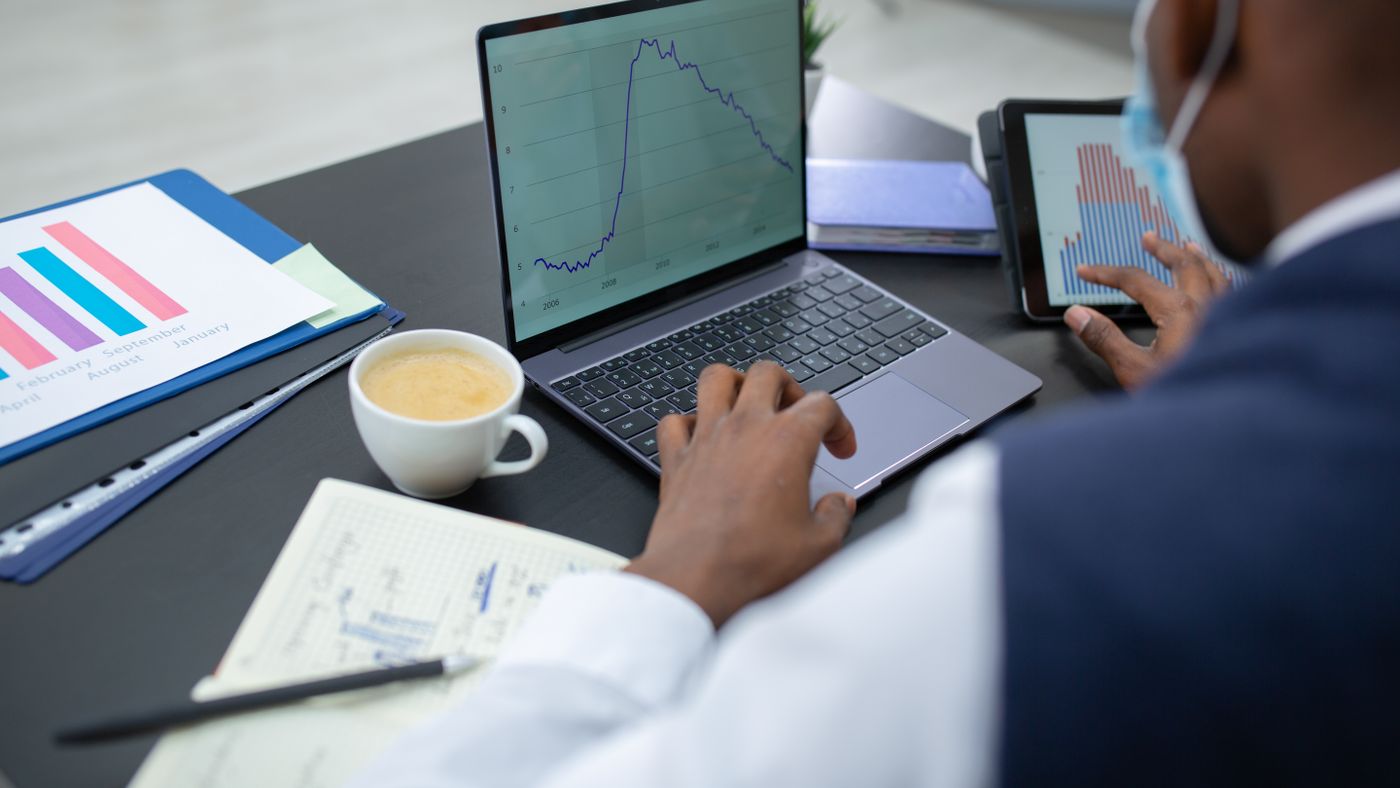 Illustration: Mikhail Nilov / Pexels Professional comparing a chart on a laptop with another on a tablet