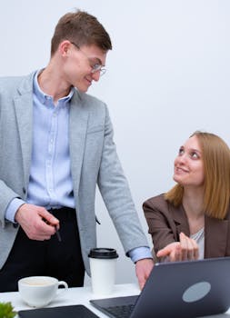Professional interaction between colleagues at work. Smiling and engaging in a modern office.