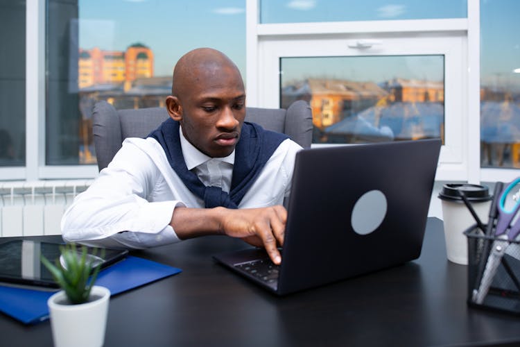 A Man Looking At The Laptop