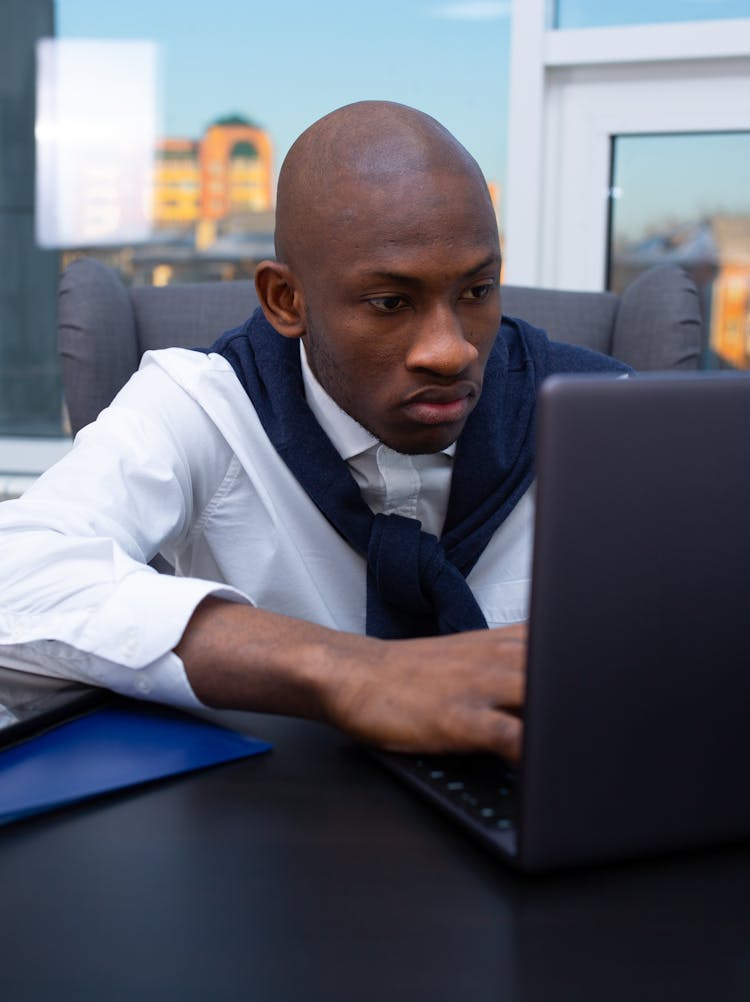 A Man Looking At The Laptop