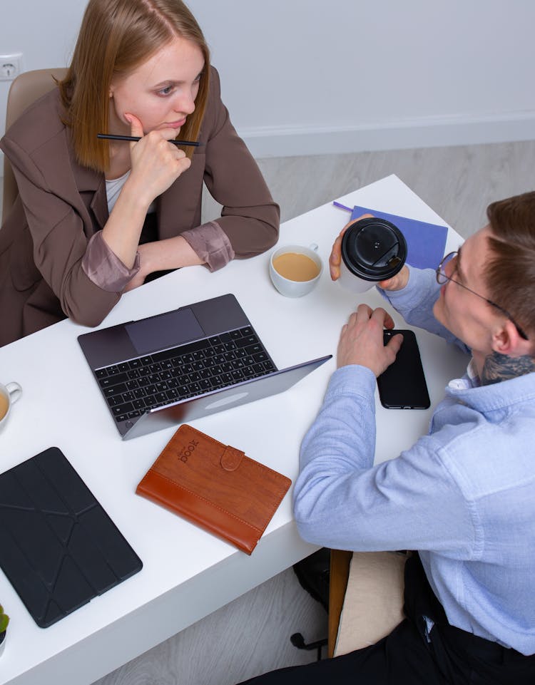 Man And Woman Sitting At The Table