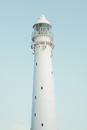 White and Black Lighthouse Under Blue Sky