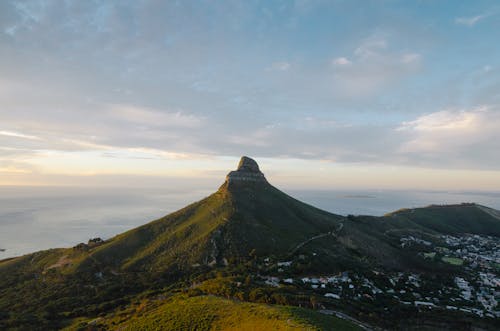 A Town Near Green Mountain Under Blue Sky