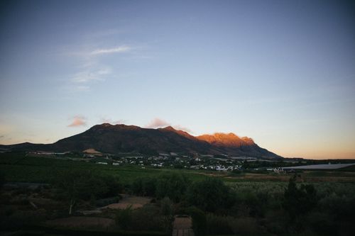 Free Tranquil landscape of a sunlit mountain and valley scene during sunset. Stock Photo
