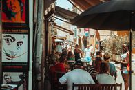 People Sitting on Chair Under Blue Umbrella