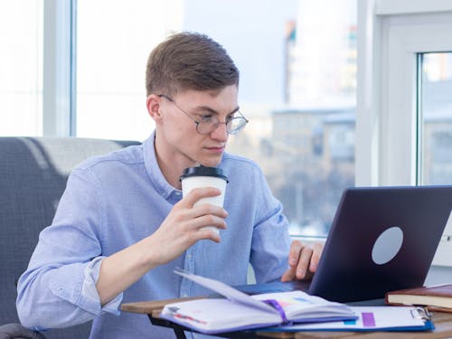 Man Wearing Eyeglasses while Working in the Office