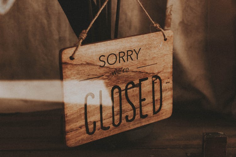 Wooden Sign Closed Hanging In Shop