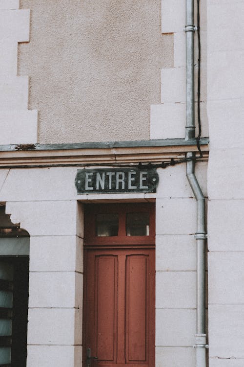 Sign Entree over door of building