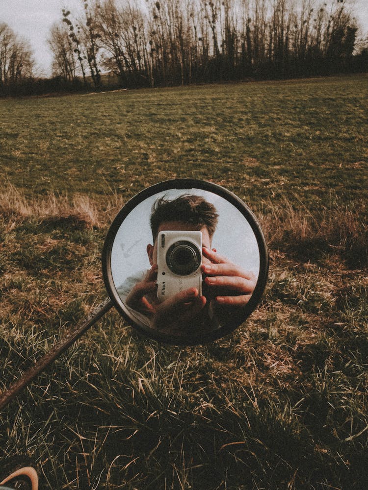 Man Taking Picture With Camera In Mirror