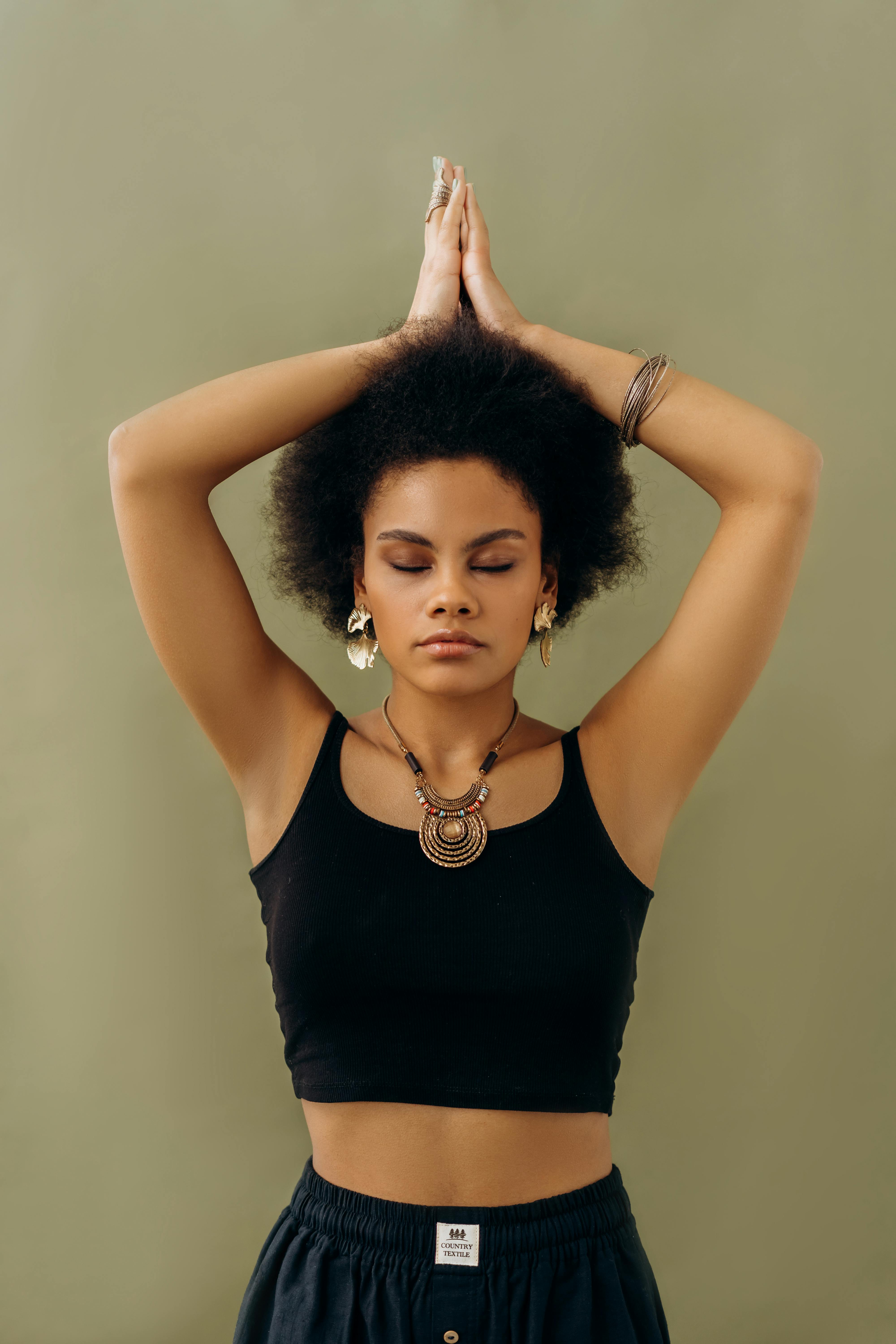 woman in black tank top holding her hair