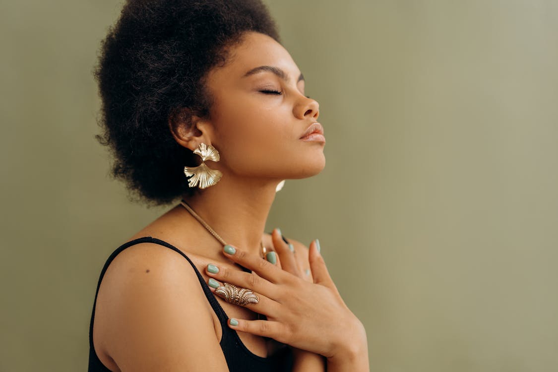 woman in black spaghetti strap top meditating 