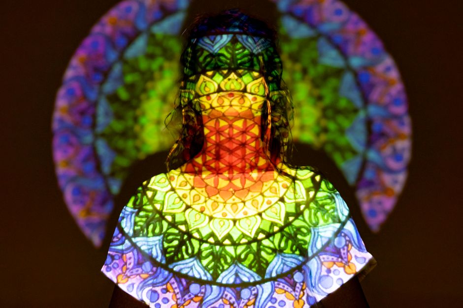 A captivating image of a woman enveloped in vibrant auras symbolizing spiritual enlightenment