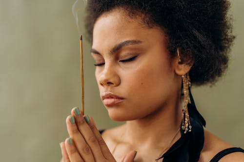 Woman with Eyes Closed Holding an Incense